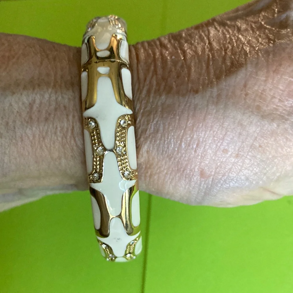 NWOT hinged rd. bracelet w/white enamel between gold designs. $25 - Picture 2 of 6